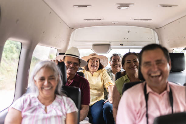 Older adults laughing together at a shared meal